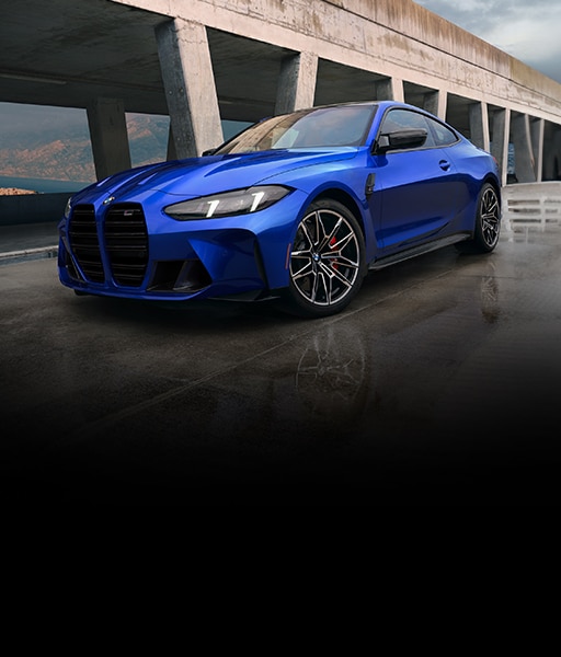 Dramatic low front view of the 2025 BMW M4 Competition xDrive Coupe in BMW Individual Marina Bay Blue metallic paint finish