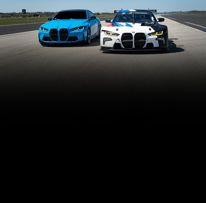 A BMW M4 GT3 driving alongside a street-model BMW M2 CS Coupe