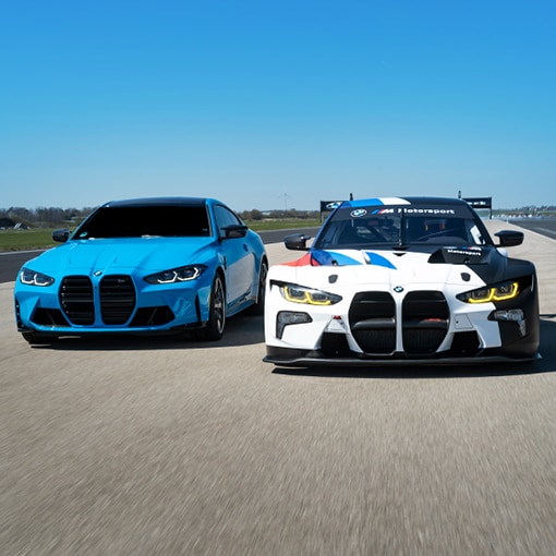 A BMW M4 GT3 driving alongside a street-model BMW M2 CS Coupe