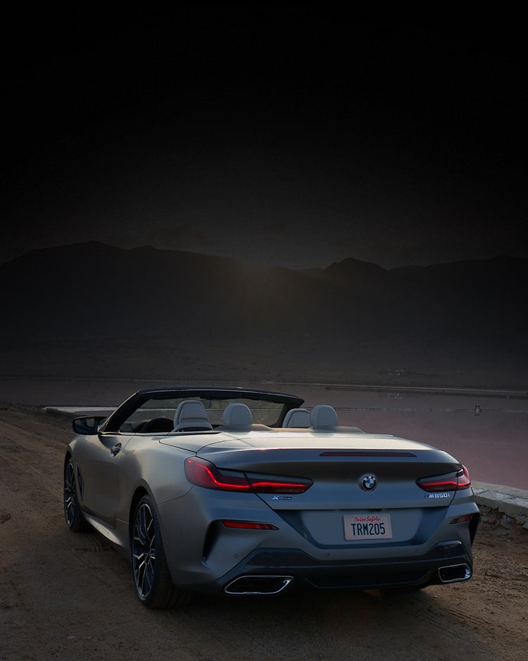 A 2026 BMW M850i xDrive Convertible parked on an open road