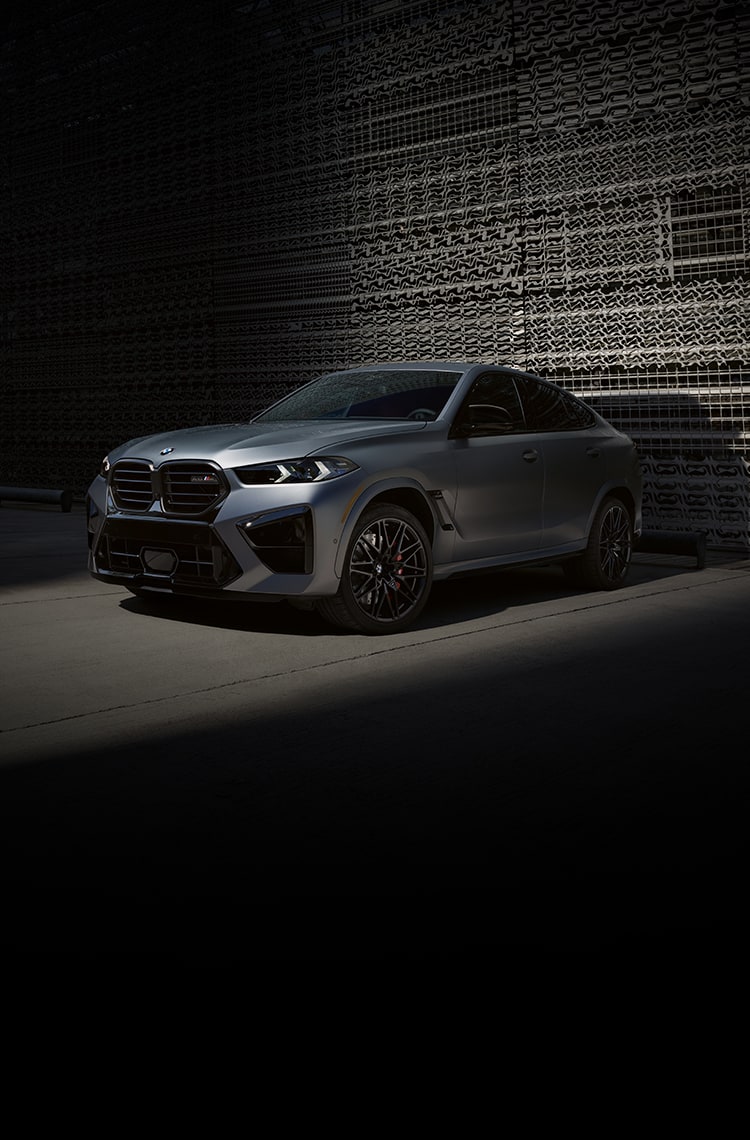 The 2026 BMW X6 M Competition Performance Coupe SUV parked in an urban parking garage