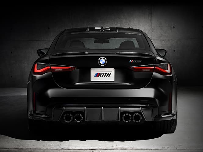 The rear of a 2022 BMW M4 Competition x Kith in Frozen Black showing quad tailpipes and Kith badging