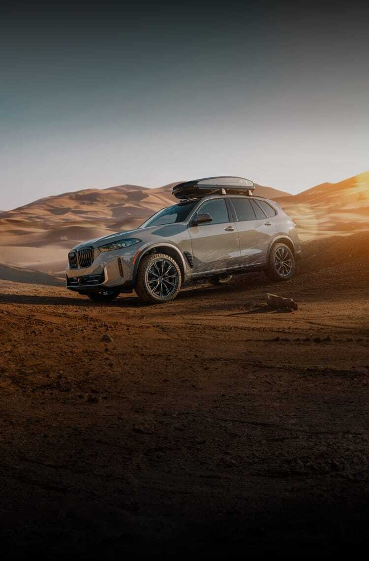 The Silver Anniversary Edition X5 SUV demonstrates incredible control as it descends a sand dune