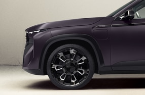 A side profile shot of the front left section of the BMW XM by Kith featuring the limited edition badging