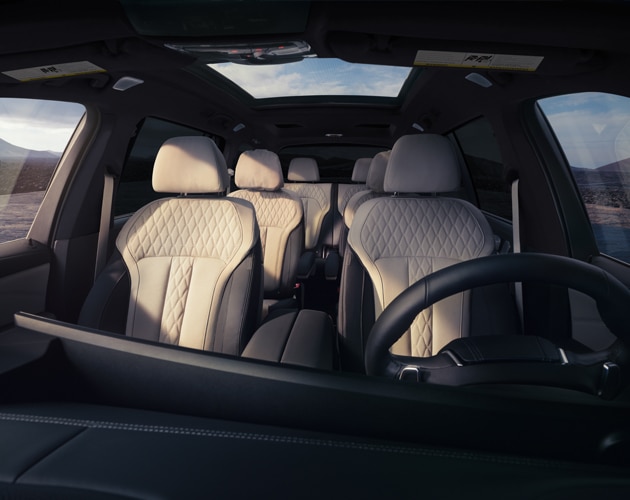The spacious inside of a BMW X7 SUV with three rows of seats